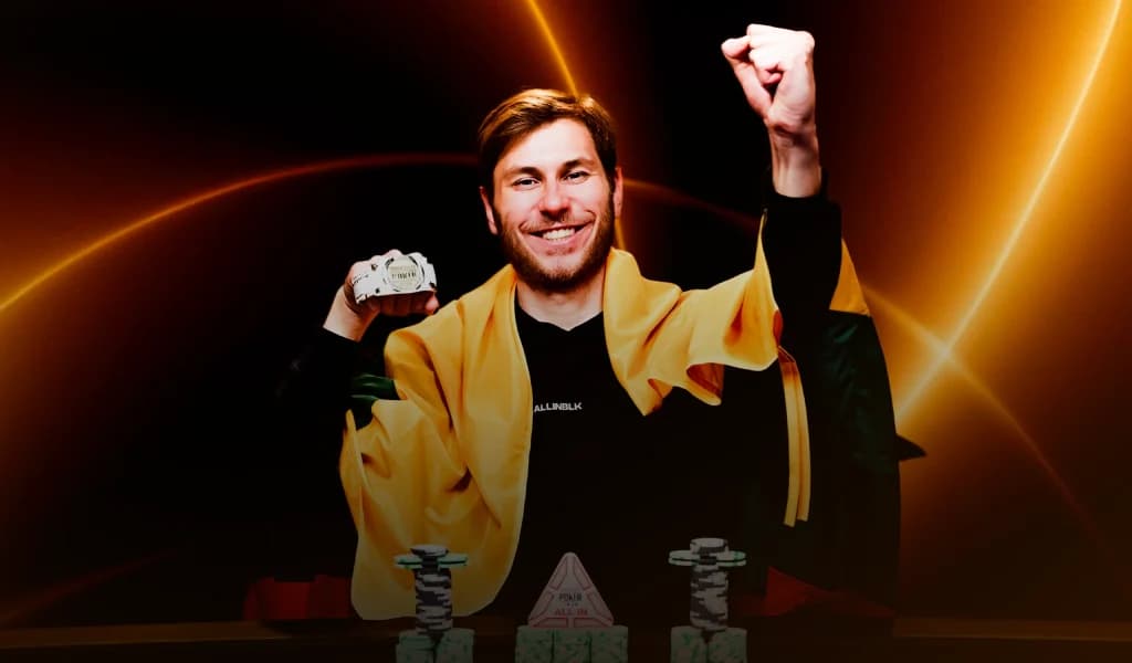 Poker player Marius Kudzmanas, celebrating a tournament win, holding a WSOP bracelet with fist raised.
