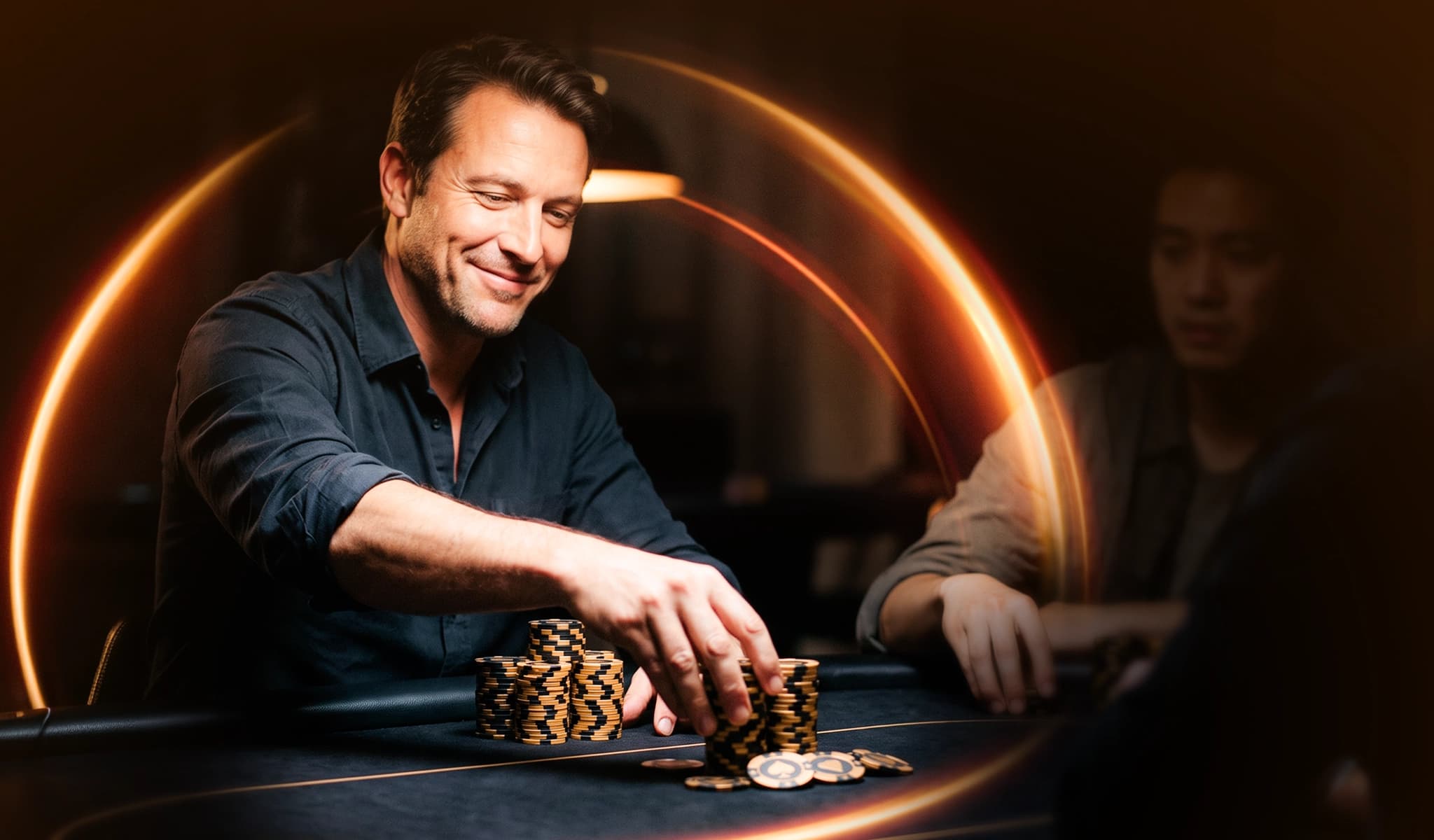 A smiling poker player reaches for a stack of chips across the table from an opponent.