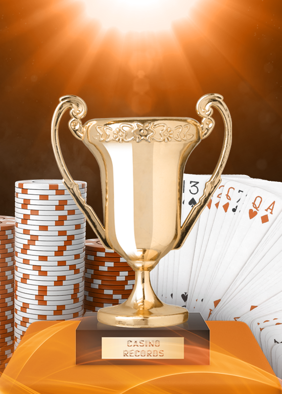 Gold Trophy in the spotlight on a platform with stacked casino chips and cards in the background with falling dice.