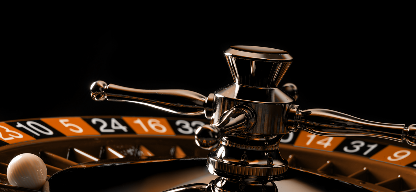 Close-up of a magnified roulette wheel on a black background.