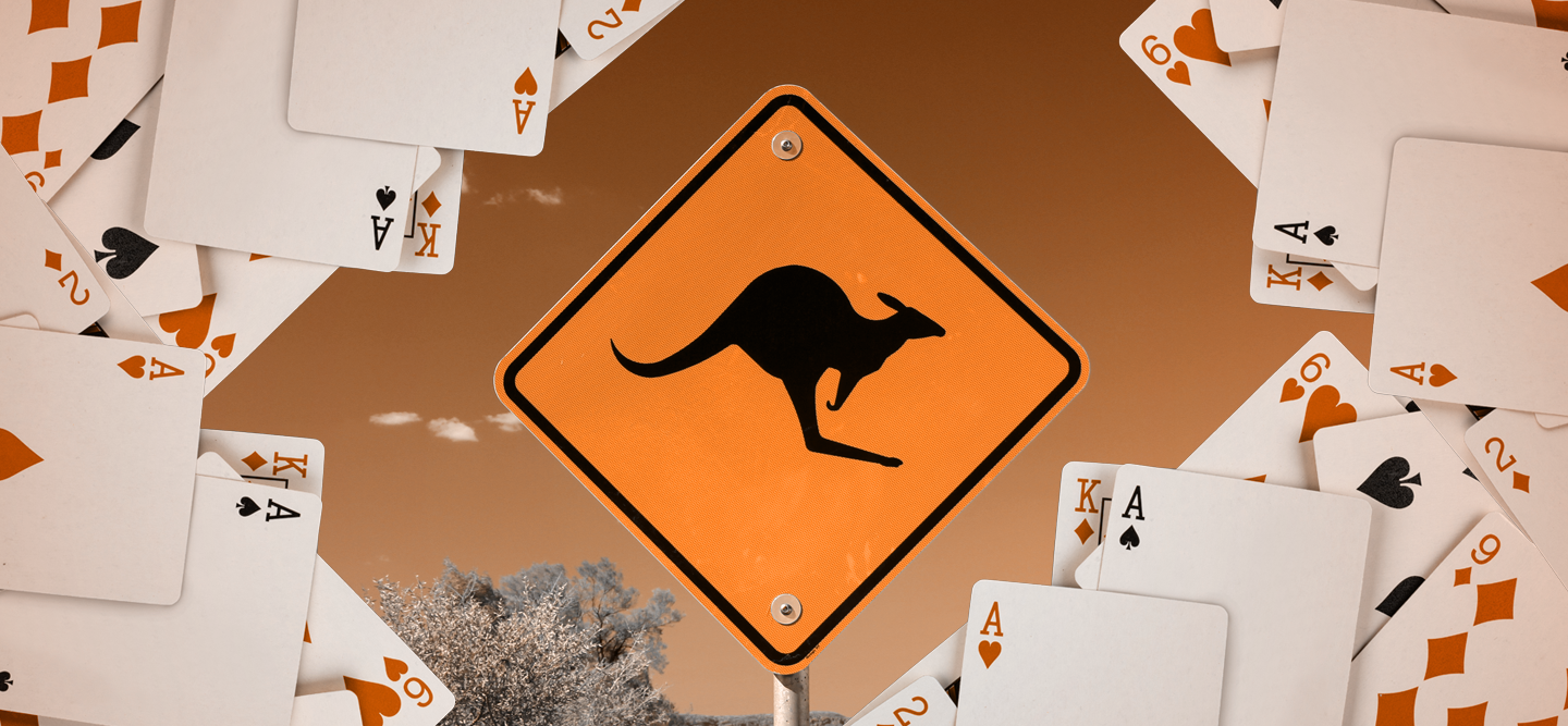 An orange caution sign with a kangaroo surrounded by cards.