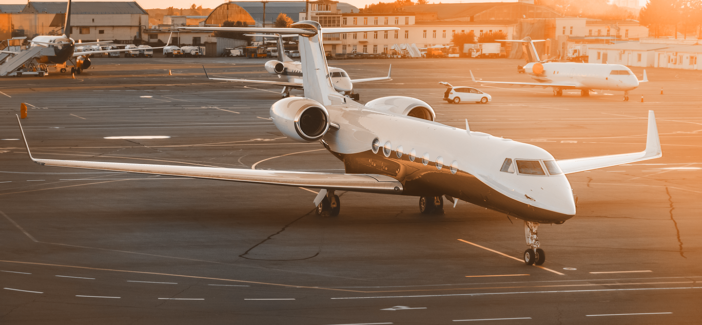 A luxury jet on the tarmac in the glow of the sunset.