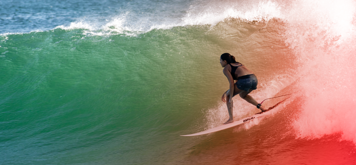 Woman surfing over big waves