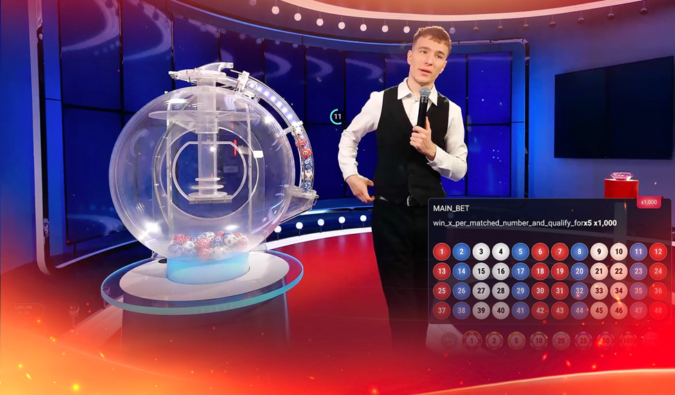 A game show host in a vest stands beside a large transparent lottery machine, explaining the 'Starzle' game in a brightly lit studio.