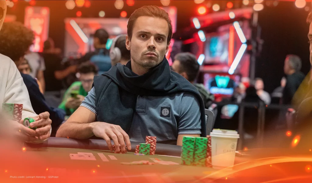 Fabian Niederreiter at WSOP poker table with chips and coffee cup in front of him, surrounded by players in a tournament hall.