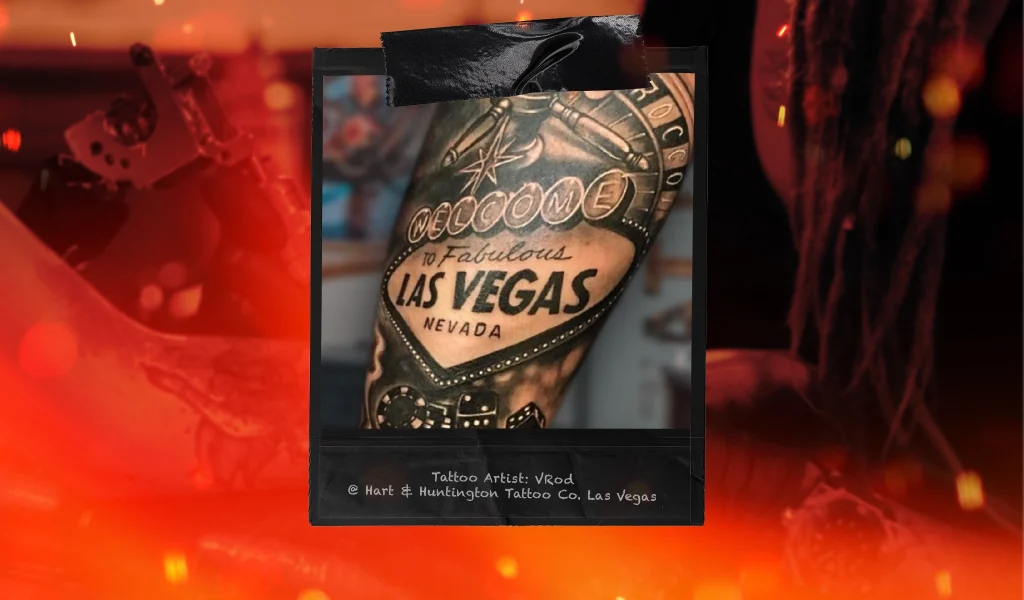 A tattoo featuring the "Welcome to Las Vegas" sign, dice, and casino elements in a bold black and grey style.