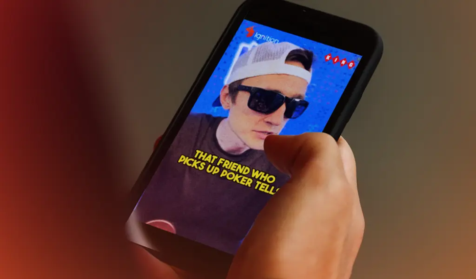 Caught on camera: Casino King sporting shades and a cap, calling out poker tells on a smartphone screen.
